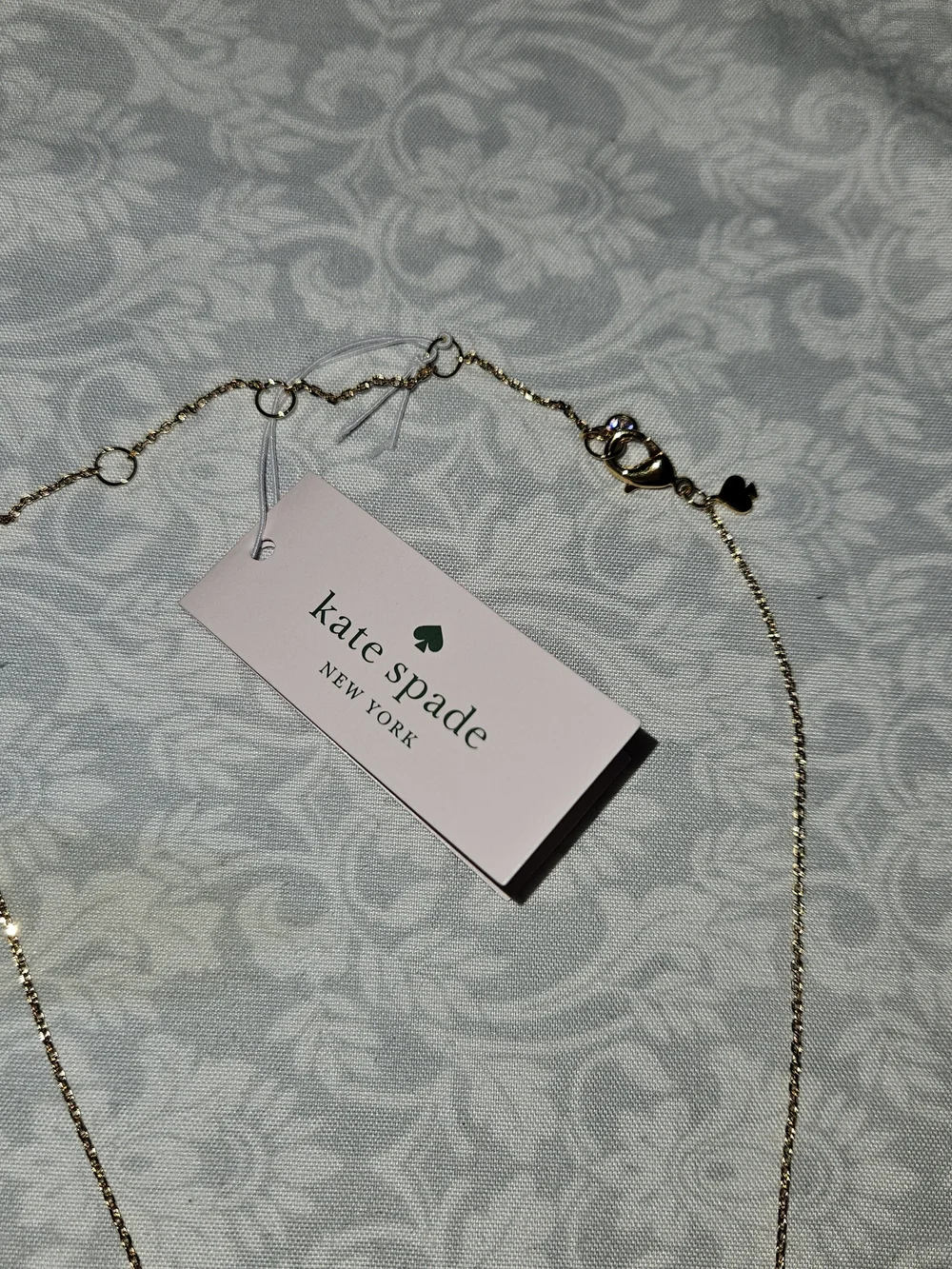 Kate Spade All Tied Up Gold Bow pendant necklace